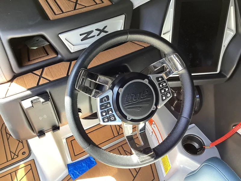 Slide: The Image of 2020 Tigé 21ZX boat steering wheel and dashboard with control buttons. - 12