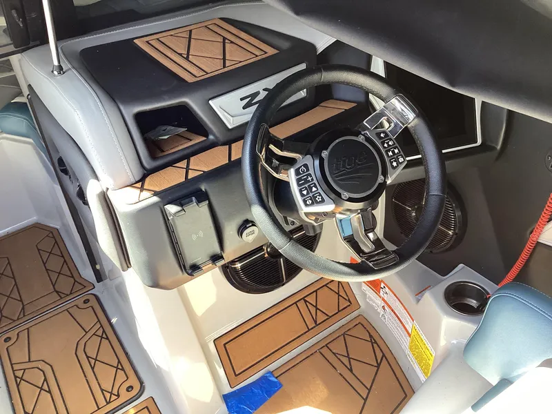 Slide: The Image of 2020 Tigé 21ZX boat interior, featuring a modern steering wheel and stylish dashboard. - 13