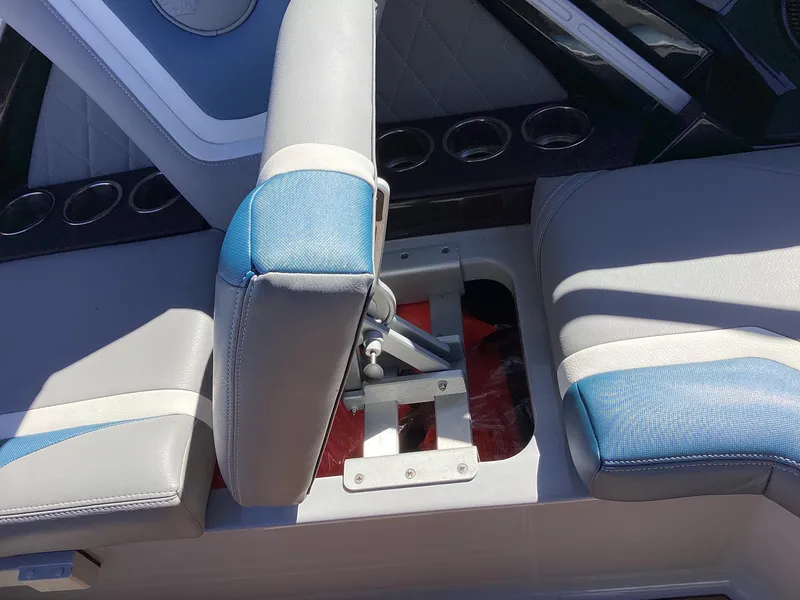 Slide: The Image of 2020 Tigé 21ZX boat interior seating with blue and white upholstery. - 2