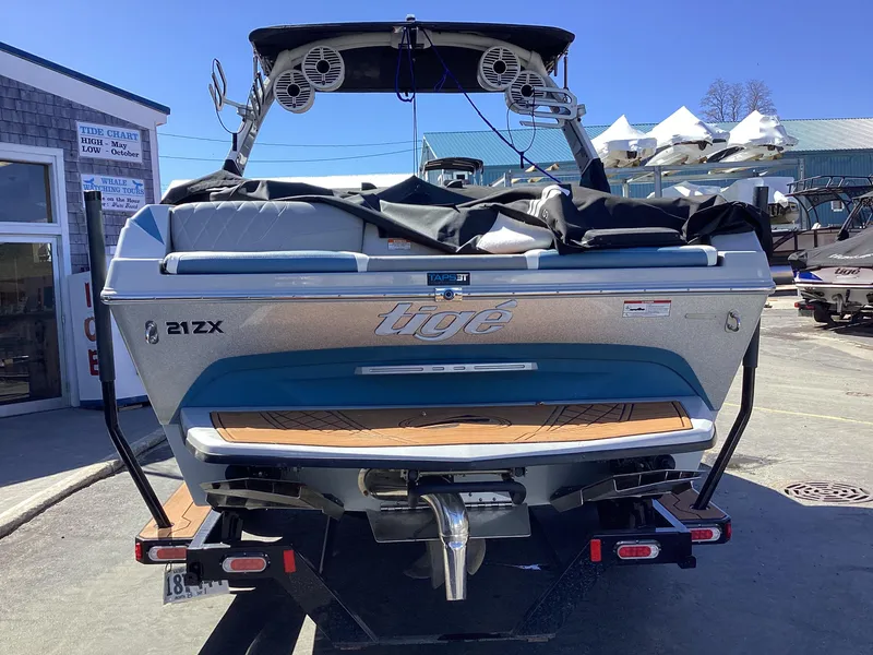 Slide: The Image of 2020 Tigé 21ZX boat on trailer, rear view, parked outdoors. - 20