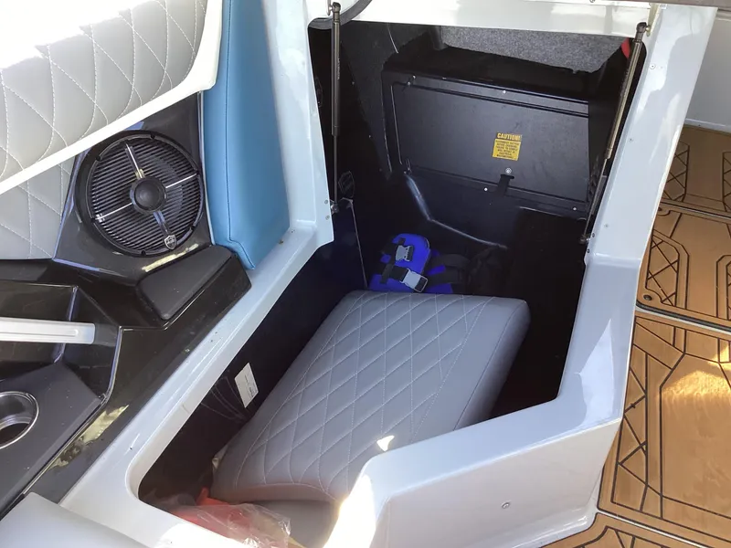 Slide: The Image of 2020 Tigé 21ZX boat interior storage compartment with seat cushion and fan. - 3