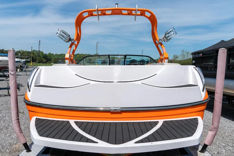 Slide: The Image of 2013 Nautique 210 SUPER AIR boat with orange and white design. - 13
