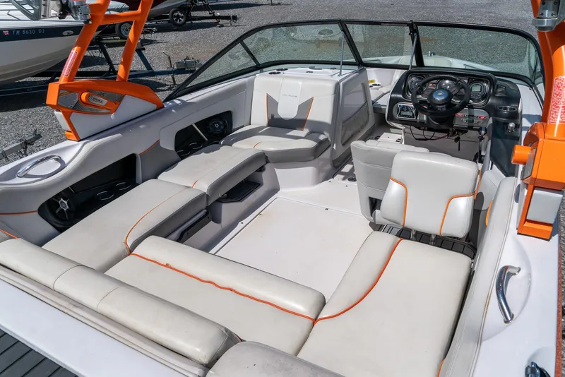 Slide: The Image of 2013 Nautique 210 Super Air boat interior with white and orange seating. - 14