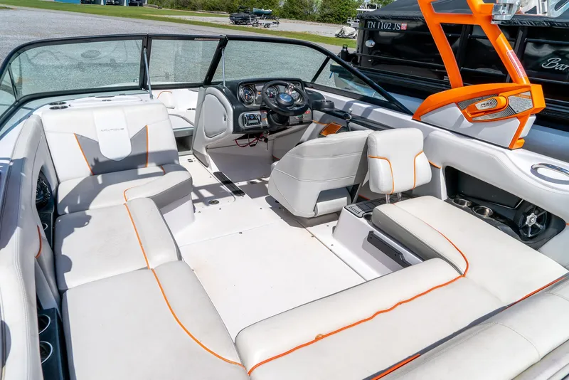 Slide: The Image of 2013 Nautique 210 SUPER AIR boat interior with white and orange seating. - 15