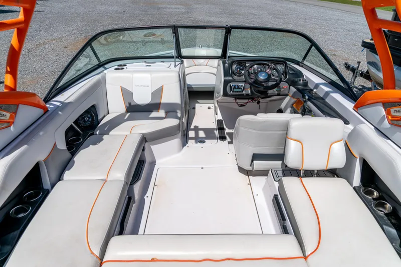 Slide: The Image of 2013 Nautique 210 SUPER AIR boat interior with white and orange seating. - 16