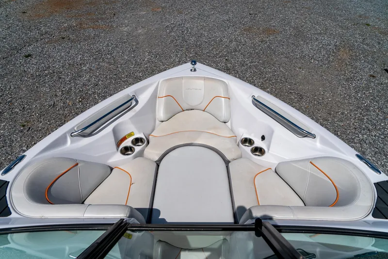 Slide: The Image of 2013 Nautique 210 SUPER AIR boat bow seating area with white and orange upholstery. - 20