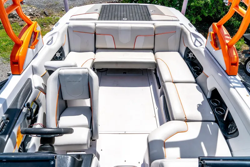 Slide: The Image of 2013 Nautique 210 SUPER AIR boat interior with white and orange seating. - 21