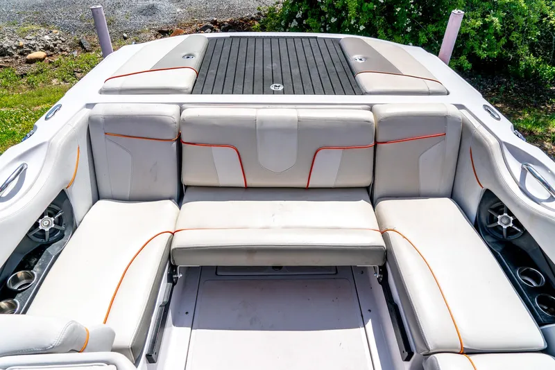 Slide: The Image of 2013 Nautique 210 Super Air boat interior with white and orange seating. - 22