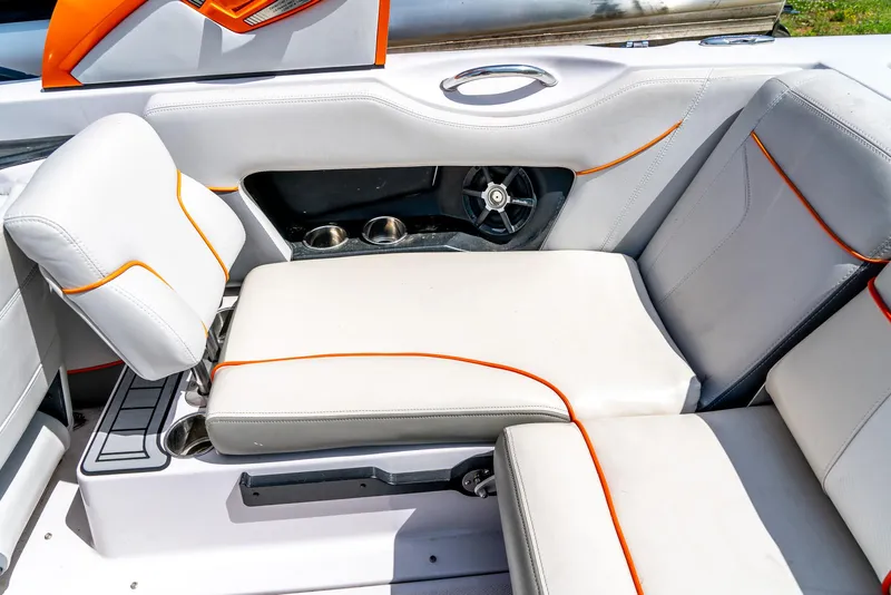 Slide: The Image of 2013 Nautique 210 SUPER AIR boat interior with white and orange seating. - 24