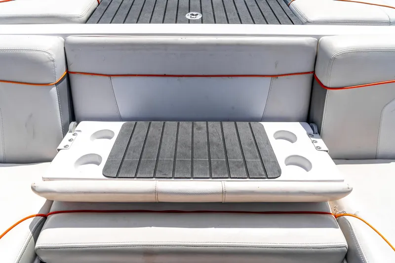 Slide: The Image of 2013 Nautique 210 SUPER AIR boat seating with integrated cup holders. - 25