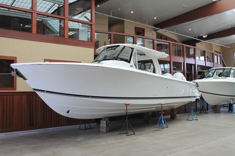 The Image of 2025 Pursuit S 358 Sport boat displayed indoors on stands. - 0