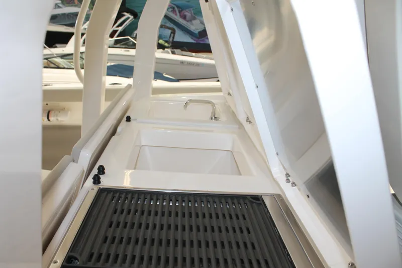 Slide: The Image of 2025 Pursuit S 358 Sport boat interior with sink and storage area. - 10