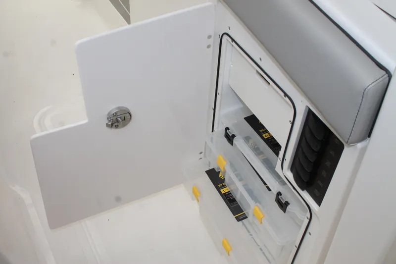 Slide: The Image of Storage compartment on the 2025 Pursuit S 358 Sport boat with organized containers. - 13