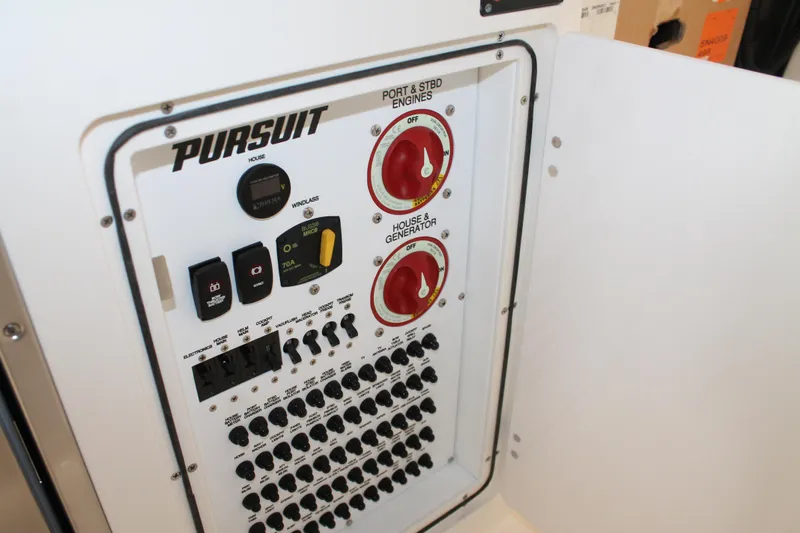 Slide: The Image of Control panel of a 2025 Pursuit S 358 Sport boat with switches and dials. - 15