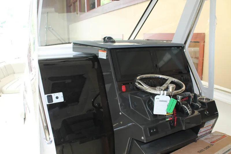 Slide: The Image of 2025 Pursuit S 358 Sport boat dashboard with steering wheel and controls. - 17