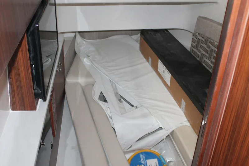 Slide: The Image of Interior cabin of 2025 Pursuit S 358 Sport boat with storage items. - 19