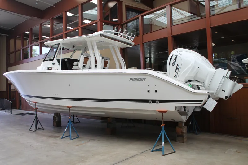 Slide: The Image of 2025 Pursuit S 358 Sport boat on display indoors. - 2