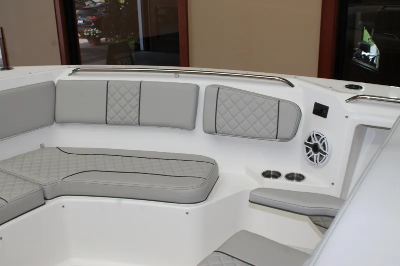 Slide: The Image of Interior seating of 2025 Pursuit S 358 Sport boat with gray cushions and cup holders. - 22