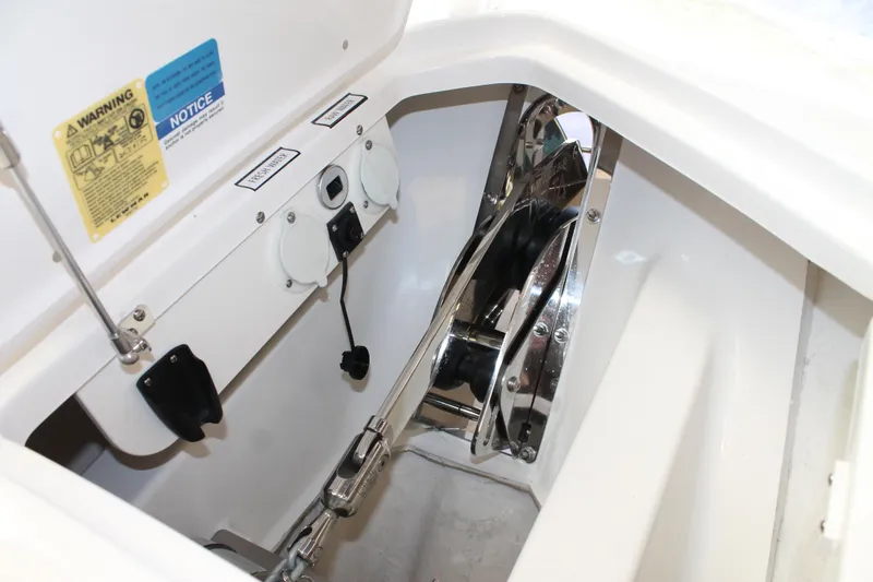 Slide: The Image of 2025 Pursuit S 358 Sport boat anchor compartment with winch and control panel. - 24