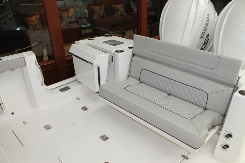 Slide: The Image of 2025 Pursuit S 358 Sport boat interior with gray cushioned seating and storage compartments. - 7