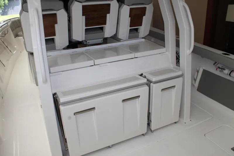 Slide: The Image of 2025 Pursuit S 358 Sport boat interior with storage compartments and seating. - 8