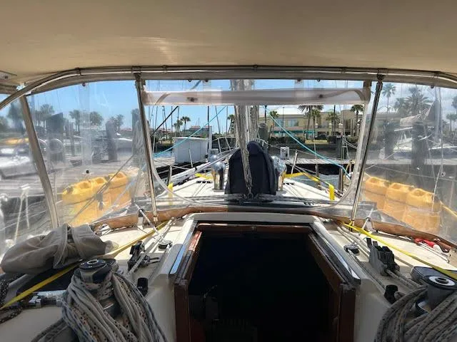 Slide: The Image of Cockpit view of a 1988 Sabre 38 sailboat docked at a marina. - 15