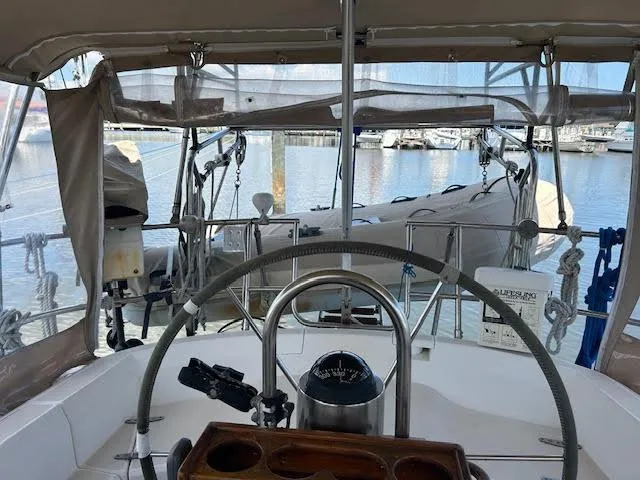 Slide: The Image of Cockpit view of a 1988 Sabre 38 sailboat docked at a marina. - 16