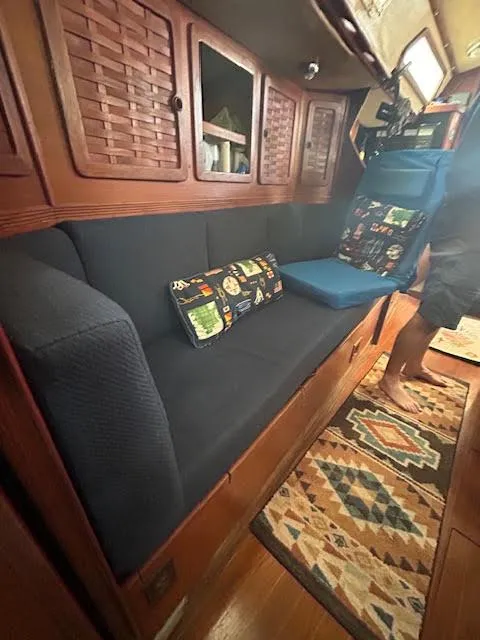 Slide: The Image of Interior of a 1988 Sabre 38 sailboat with cozy seating and wooden cabinetry. - 19