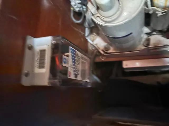 Slide: The Image of Engine compartment of a 1988 Sabre 38 sailboat with mechanical components. - 24