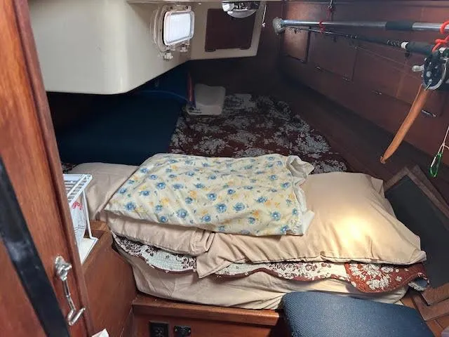 Slide: The Image of 1988 Sabre 38 sailboat interior cabin with bedding and storage. - 25