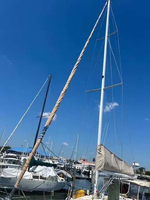 Slide: The Image of 1988 Sabre 38 sailboat docked at marina under clear blue sky. - 3