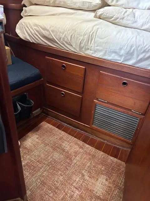 Slide: The Image of 1988 Sabre 38 interior cabin with wooden drawers and bed. - 34