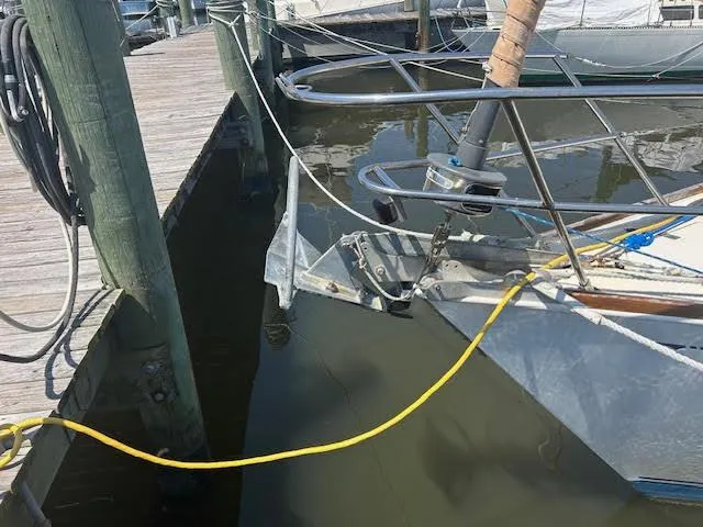 Slide: The Image of 1988 Sabre 38 sailboat docked at marina with anchor and yellow power cord. - 38