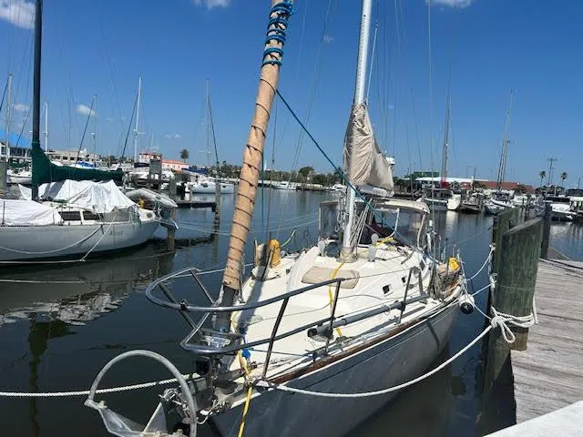 Slide: The Image of 1988 Sabre 38 sailboat docked at a marina on a sunny day. - 4