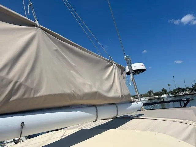 Slide: The Image of 1988 Sabre 38 sailboat with covered mainsail and radar, docked at marina. - 6