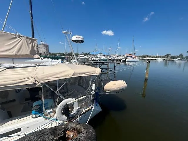 Slide: The Image of 1988 Sabre 38 sailboat docked at a marina on a sunny day. - 7