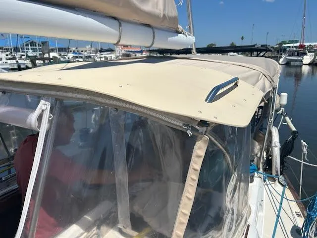 Slide: The Image of 1988 Sabre 38 sailboat with beige canopy docked at marina. - 8