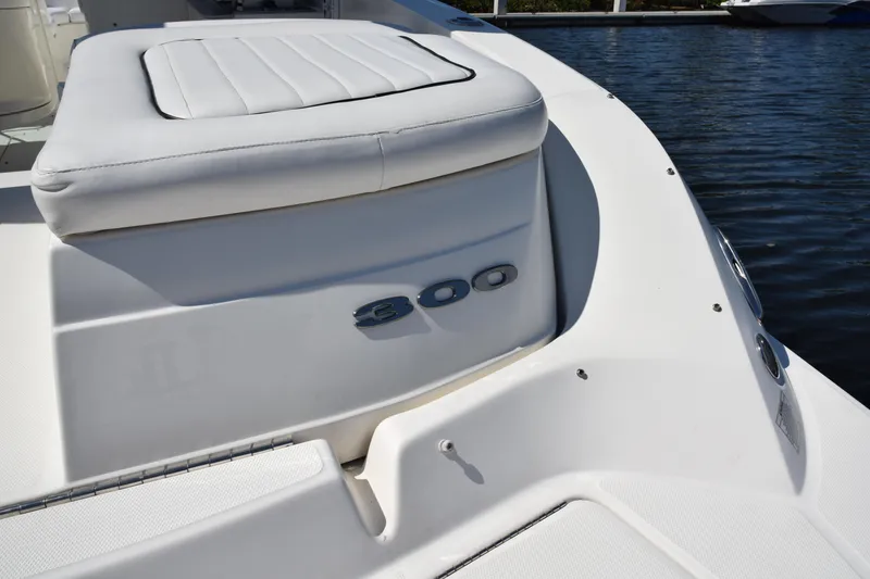 Slide: The Image of 2009 Sea Ray 300 SLX boat, white seating, docked on calm water. - 14