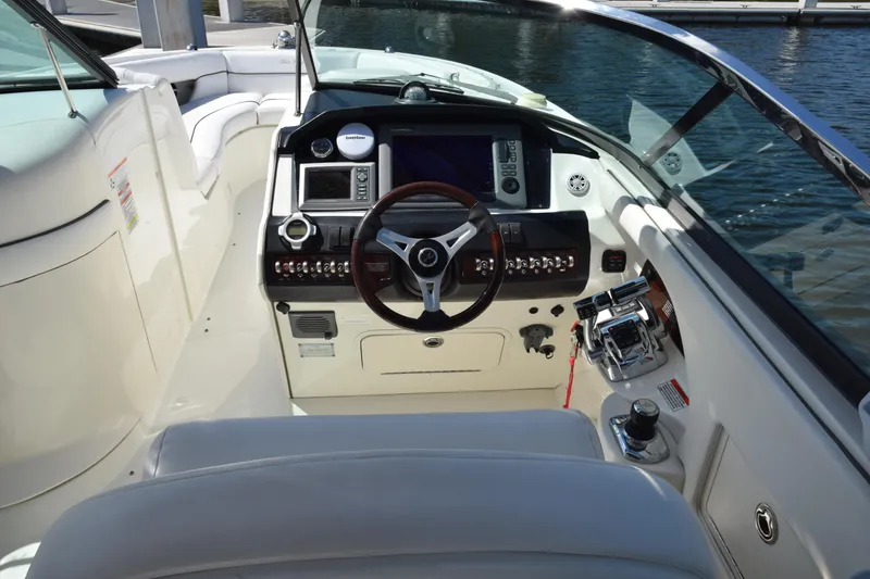Slide: The Image of 2009 Sea Ray 300 SLX boat cockpit with steering wheel and control panel. - 19