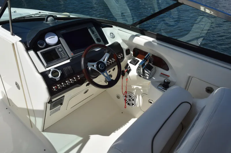 Slide: The Image of 2009 Sea Ray 300 SLX boat cockpit with steering wheel, controls, and navigation equipment. - 20