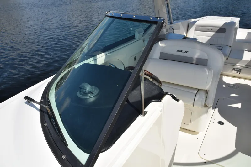 Slide: The Image of 2009 Sea Ray 300 SLX boat interior with seating and windshield on water. - 24