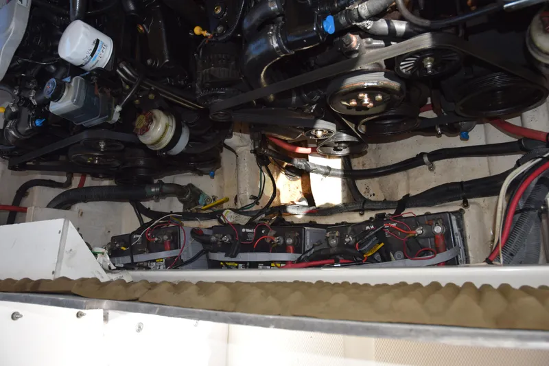 Slide: The Image of Engine compartment of a 2009 Sea Ray 300 SLX, showing batteries and mechanical components. - 35