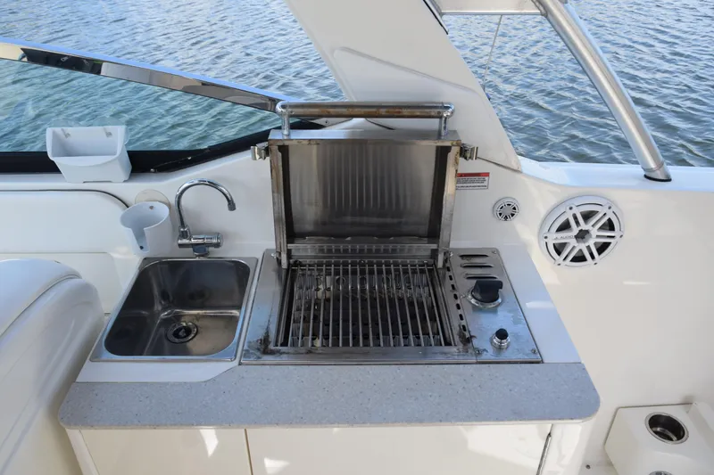 Slide: The Image of Outdoor kitchen on 2009 Sea Ray 300 SLX boat with grill and sink. - 36