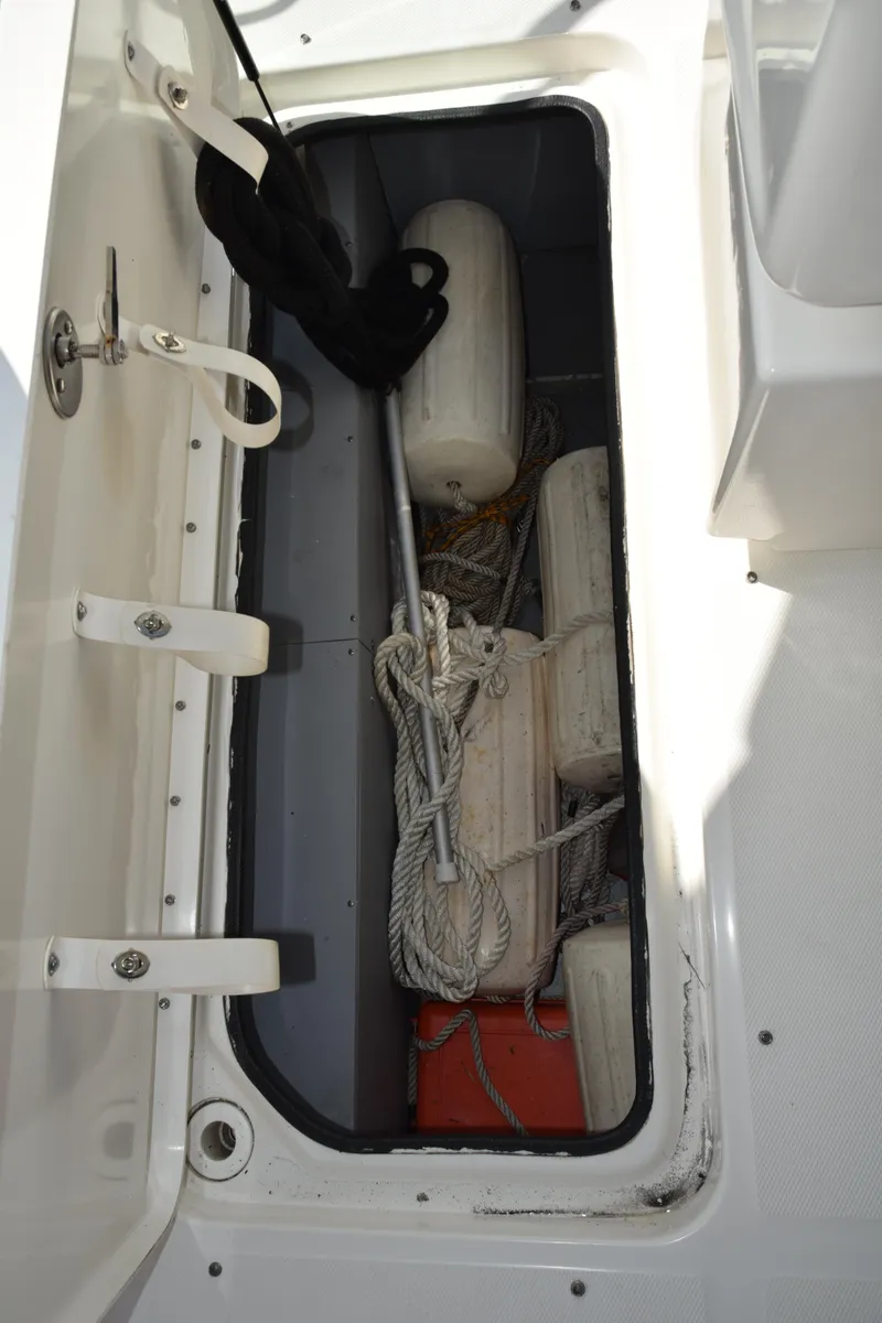 Slide: The Image of Storage compartment on a 2009 Sea Ray 300 SLX boat with ropes and fenders. - 37