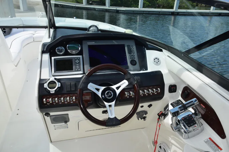 Slide: The Image of Cockpit of 2009 Sea Ray 300 SLX boat with steering wheel and control panel. - 38
