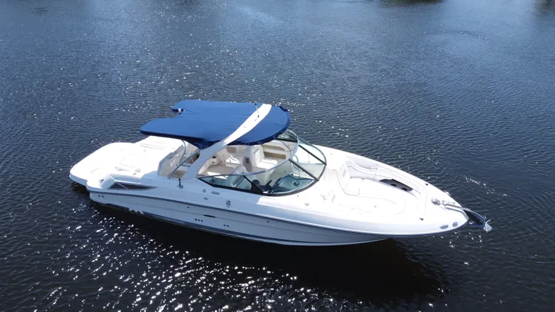 Slide: The Image of 2009 Sea Ray 300 SLX boat with blue canopy on calm water. - 7