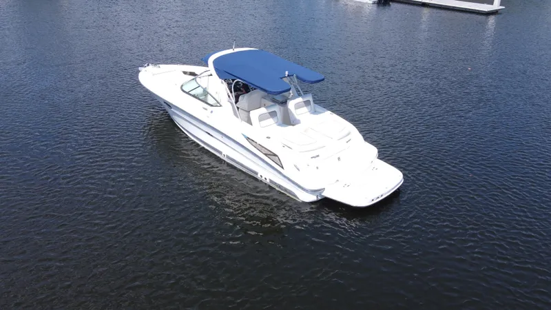 Slide: The Image of 2009 Sea Ray 300 SLX boat with blue canopy on calm water. - 8
