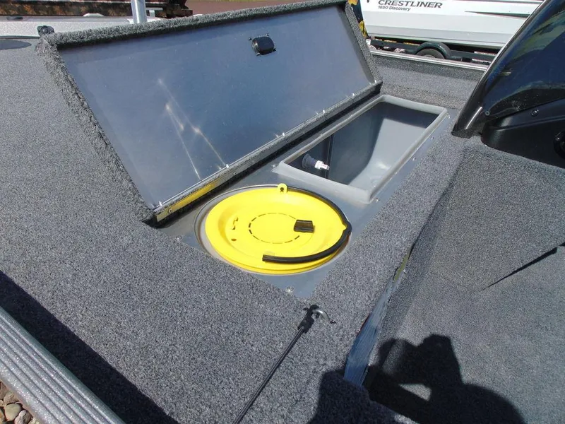 Slide: The Image of 2024 Crestliner 1600 Storm boat storage compartment with yellow lid. - 5