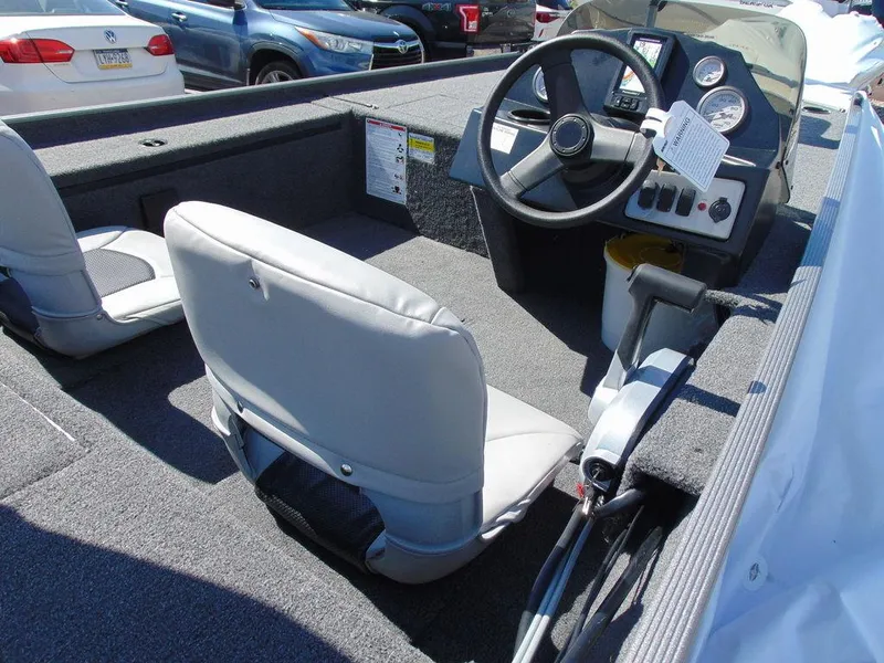 Slide: The Image of 2024 Crestliner 1600 Storm boat interior with steering console and seating. - 7