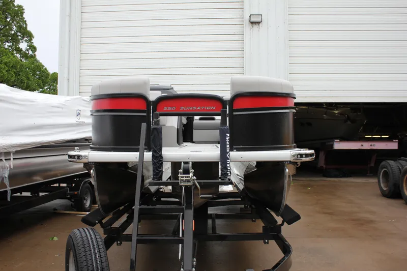 Slide: The Image of 2024 Premier 230 SunSation Angler pontoon boat on a trailer in a storage facility. - 11